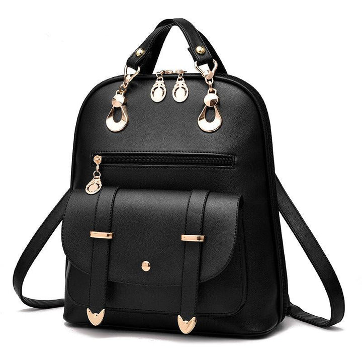 Black leather backpack with gold hardware, front pocket, zipper, and dual handles on white background