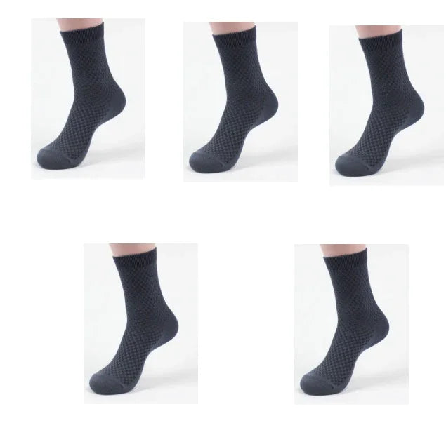 Five views of black textured crew socks on model foot against white background
