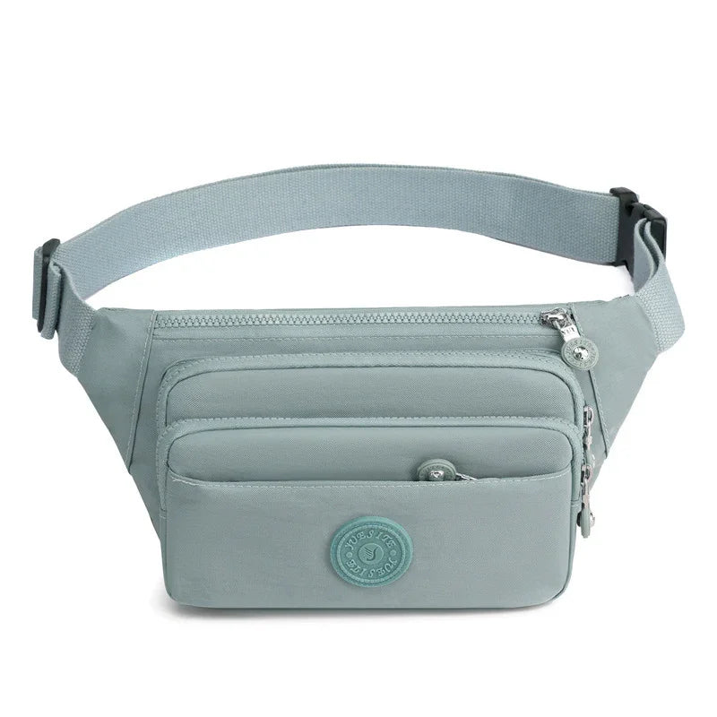Light blue nylon waist bag with multiple zippered compartments and adjustable strap