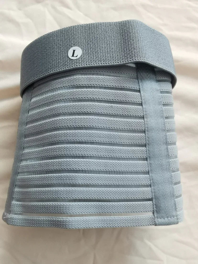 Large size grey elastic lumbar support belt with horizontal stripes on white fabric