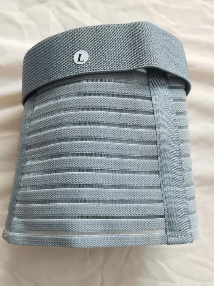 Large size grey elastic lumbar support belt with horizontal stripes on white fabric