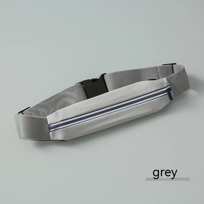Grey running belt with zipper pocket and adjustable strap on light grey background