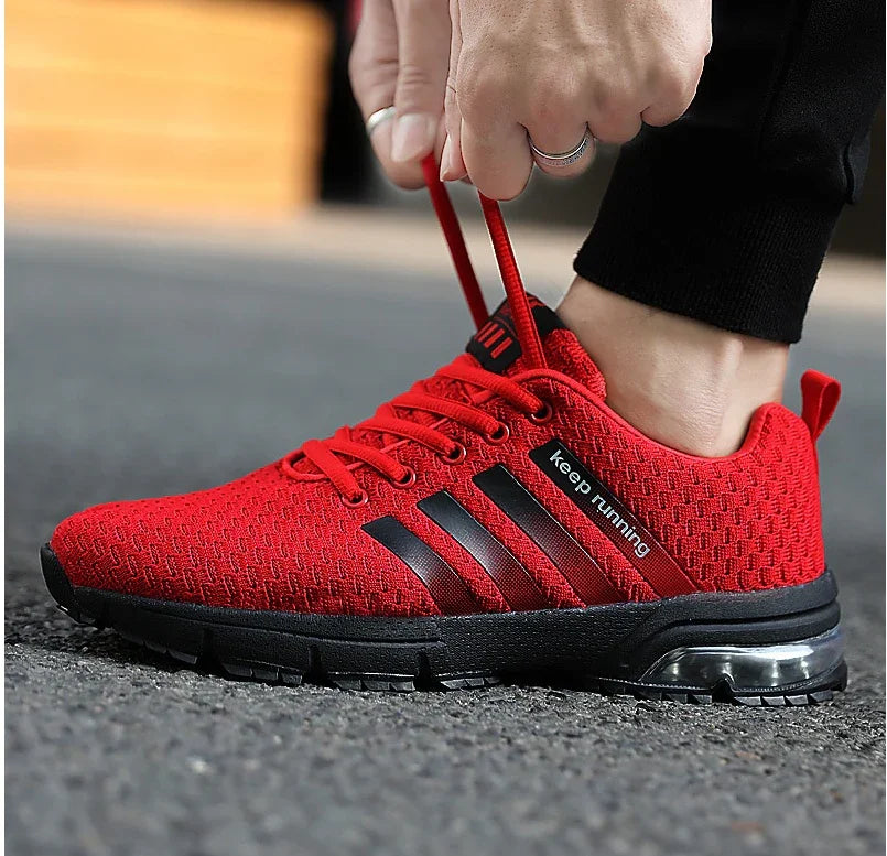 Close-up of red running shoe with black sole and stripes, featuring 'keep running' text, laced up