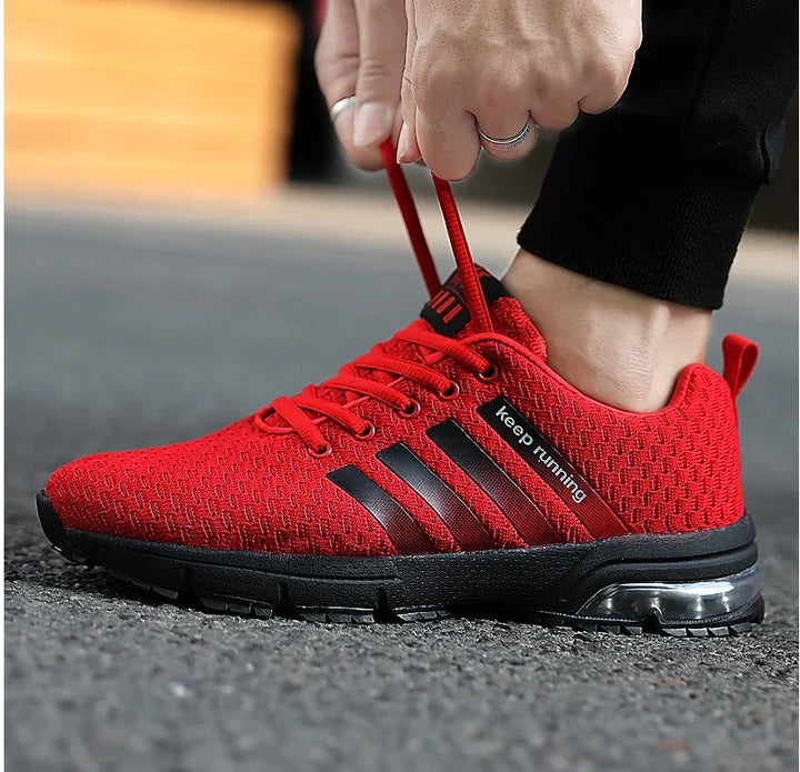Close-up of red running shoe with black sole and stripes, featuring 'keep running' text, laced up