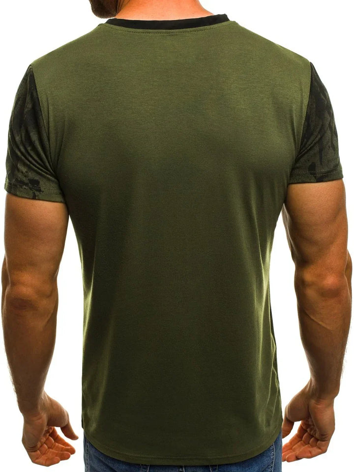 Back view of a man wearing an olive green t-shirt with black camouflage sleeves and jeans
