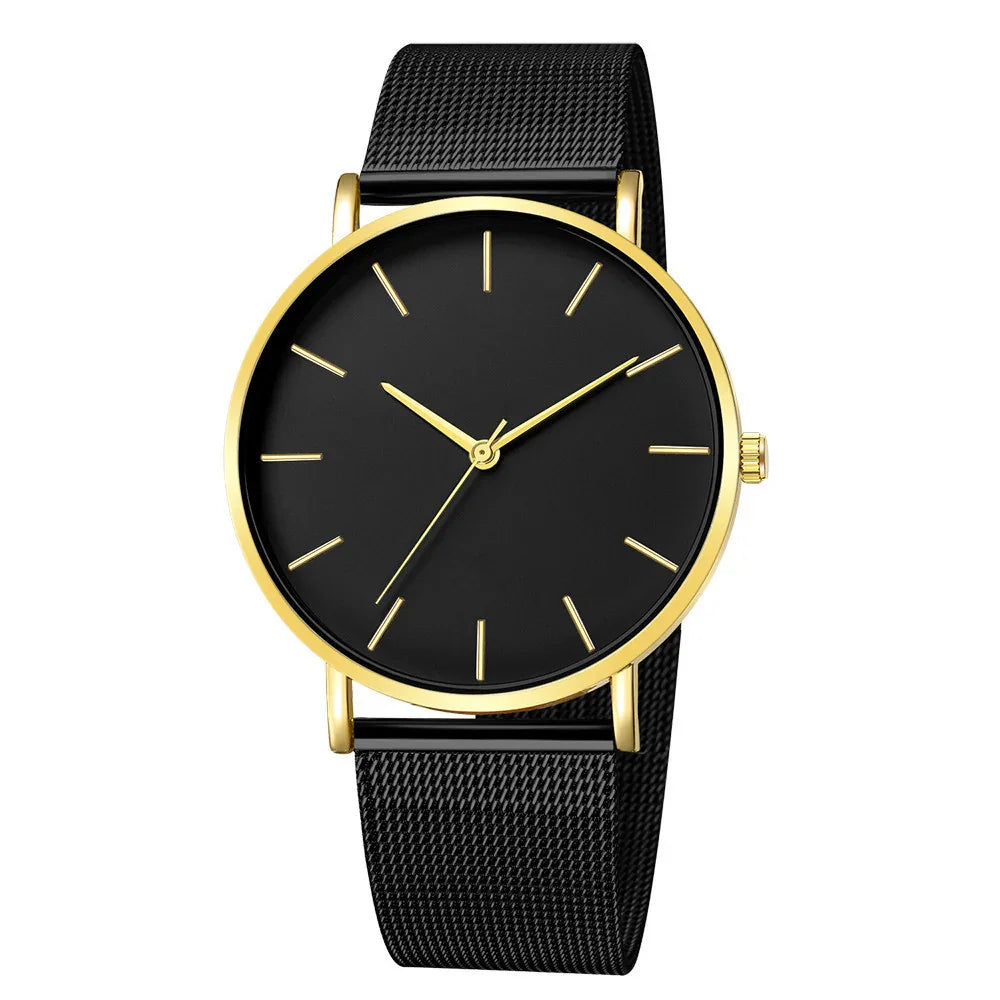 Elegant black wristwatch with gold case and minimalist gold hour markers on black mesh strap