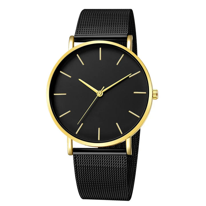 Elegant black wristwatch with gold case and minimalist gold hour markers on black mesh strap