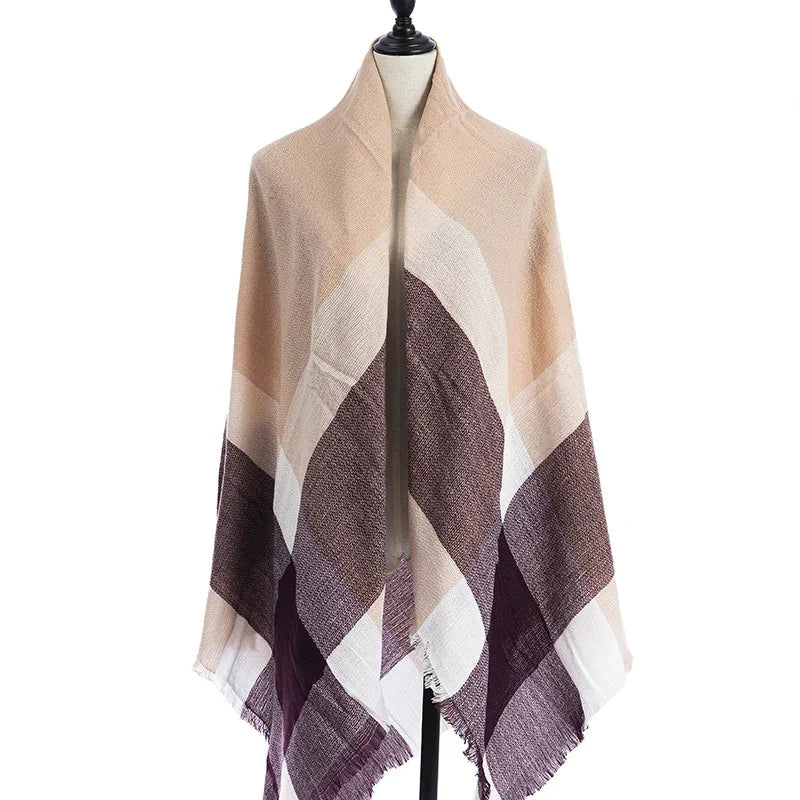 Beige, brown, and cream geometric patterned shawl or wrap displayed on a dress form with fringed edges