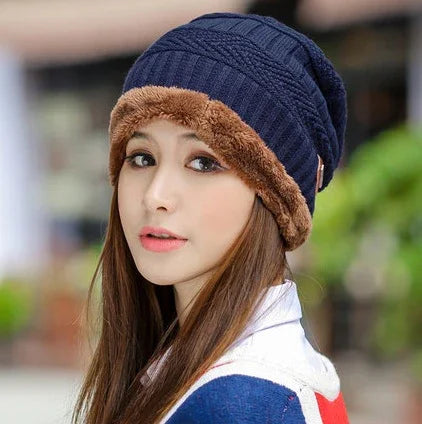 woman wearing navy blue knit beanie with brown fur trim, outdoor portrait