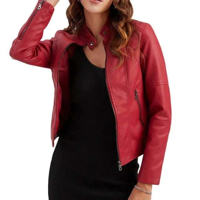 Woman wearing a stylish red leather jacket over a black dress on white background