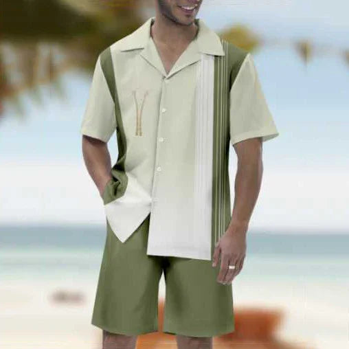 Man wearing olive green and beige short-sleeve button-up shirt and matching shorts at beach background