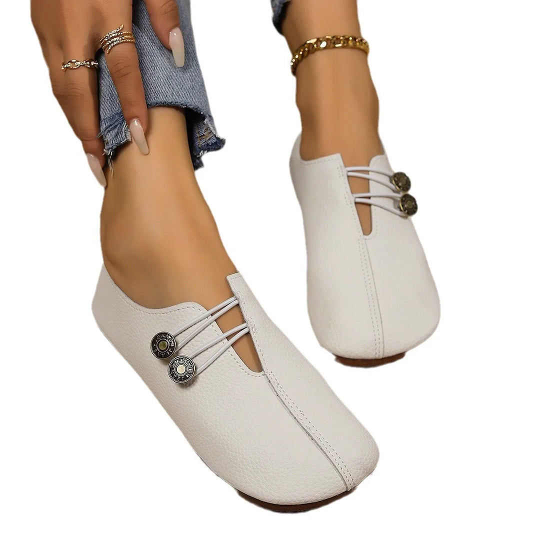 White leather slip-on women's shoes with decorative elastic straps and metallic buttons