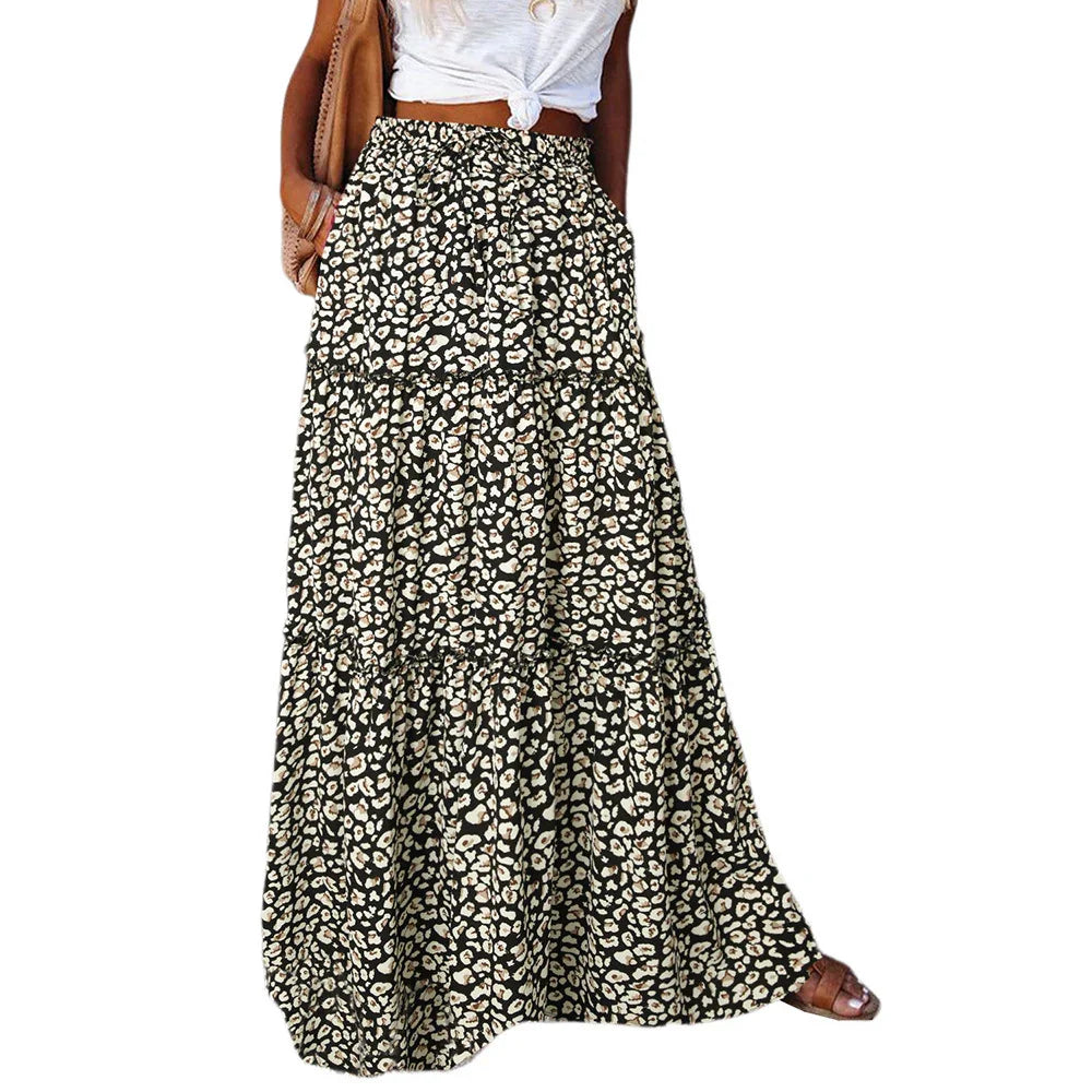 Woman wearing black and white leopard print maxi skirt with pockets and tied white top