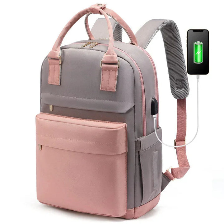 Modern grey and pink backpack with USB charging port connected to a smartphone