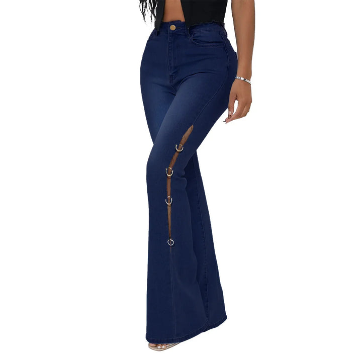 Woman wearing dark blue high-waisted flared jeans with side cutout and metal ring details
