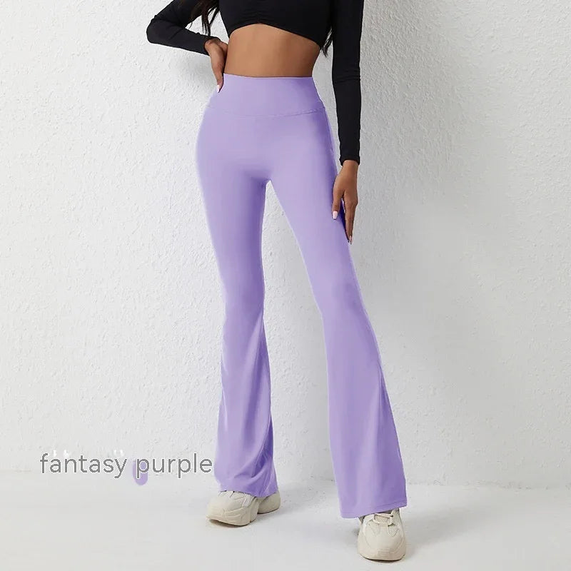 Woman wearing fantasy purple high-waisted flare pants with white sneakers and black cropped top