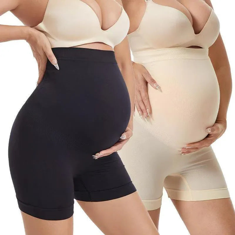 Pregnant woman wearing high-waisted maternity shapewear shorts in black and nude colors.