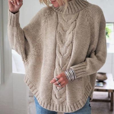 woman wearing beige chunky knit turtleneck sweater with cable pattern and silver bracelets indoors
