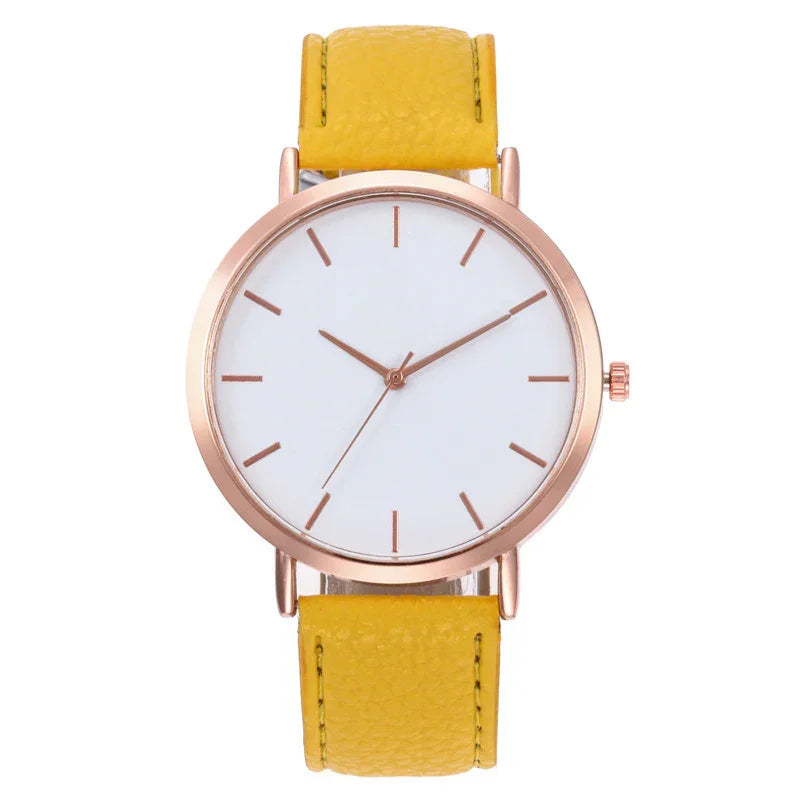 Minimalist wristwatch with rose gold case, white dial, and yellow leather strap