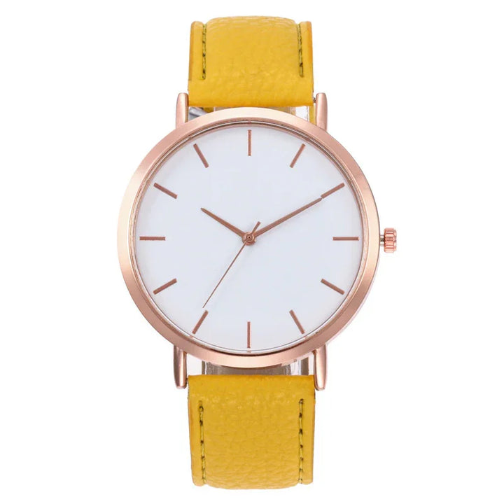 Minimalist wristwatch with rose gold case, white dial, and yellow leather strap