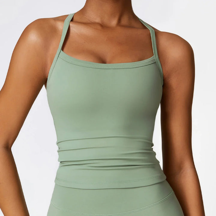 Woman wearing light green fitted square neck tank top with thin shoulder straps