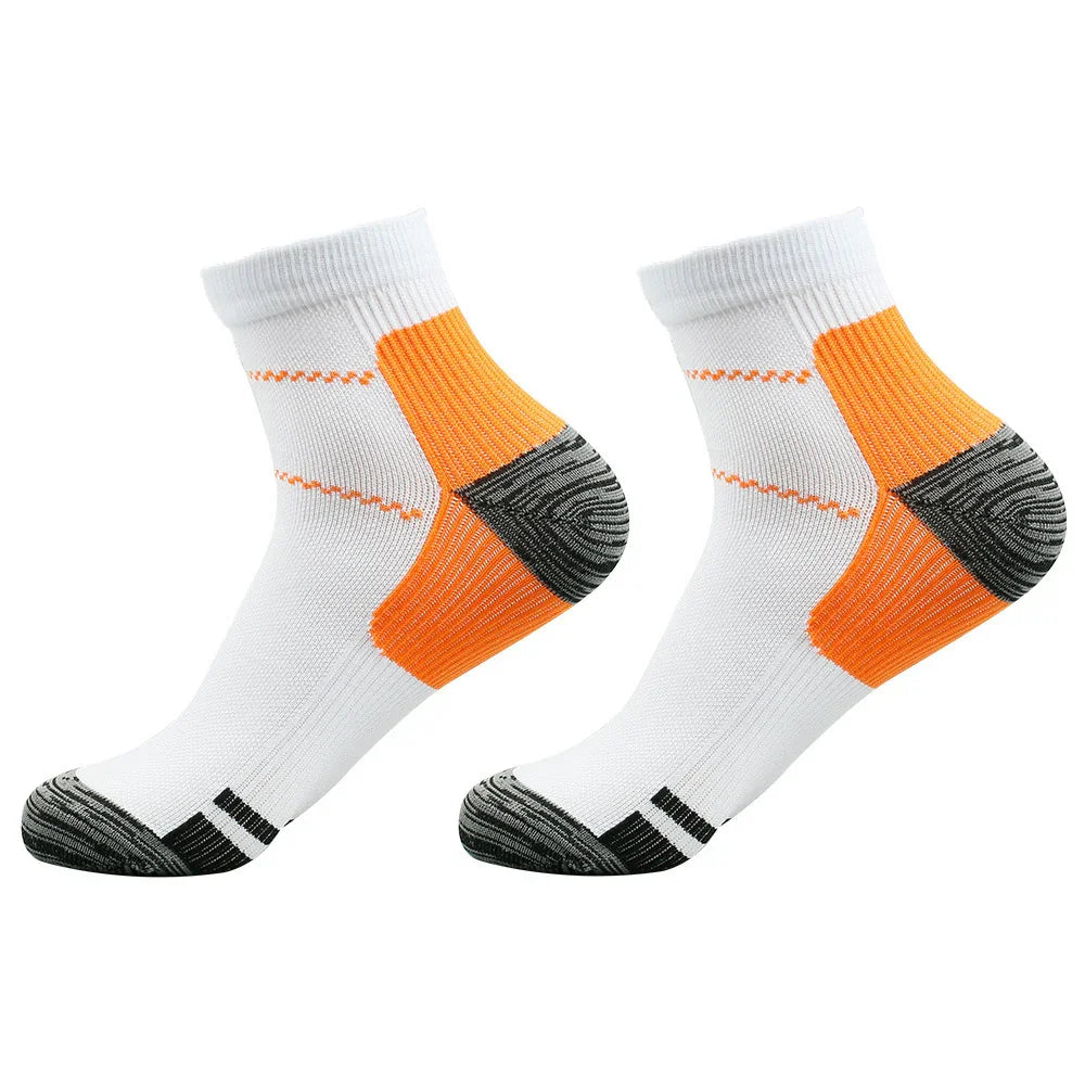 Pair of white athletic ankle socks with orange and black cushioned heel and toe areas