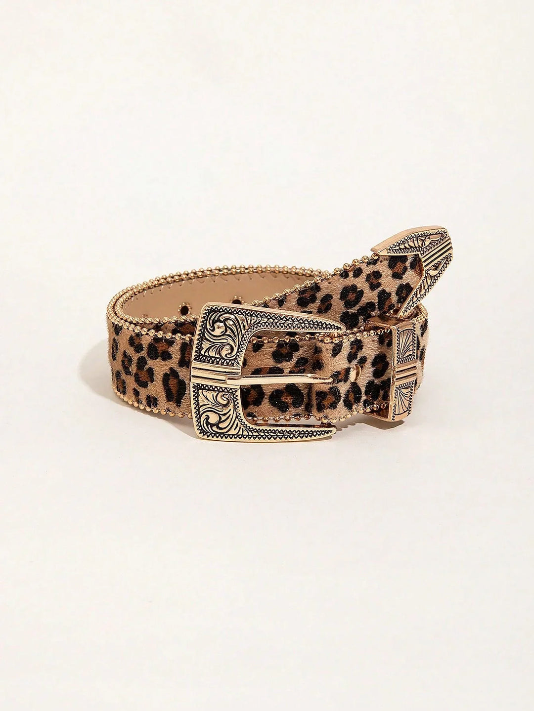 Leopard print belt with ornate gold buckle and studded edges on white background