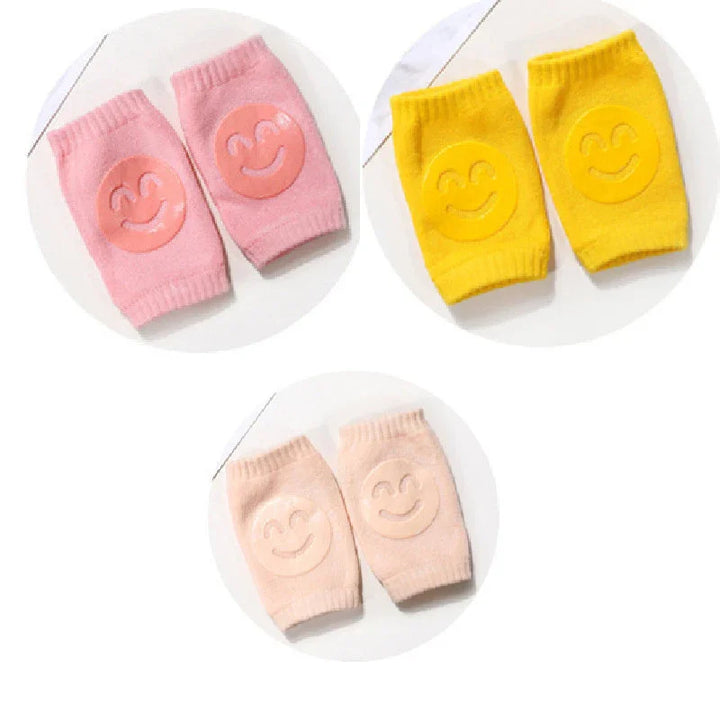 Soft knit baby leg warmers in pink, yellow, and beige with smiley face patches