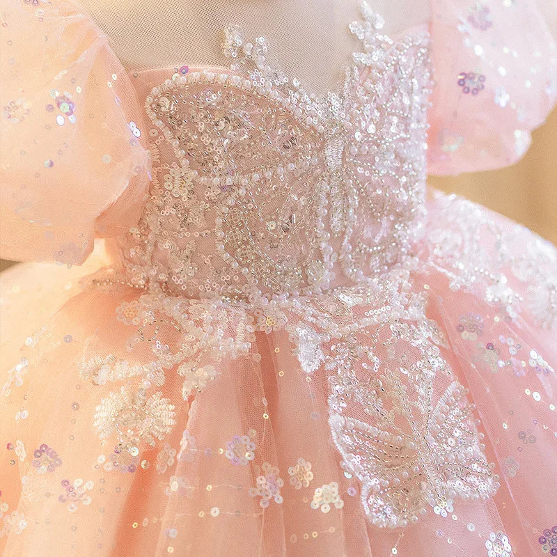 Pink sequined dress with intricate butterfly embroidery and puff sleeves for special occasions