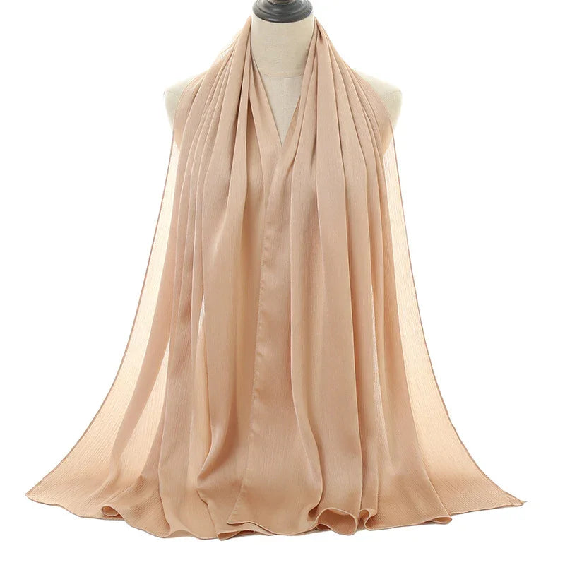 Beige lightweight chiffon scarf displayed on a mannequin with soft flowing fabric