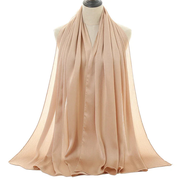 Beige lightweight chiffon scarf displayed on a mannequin with soft flowing fabric