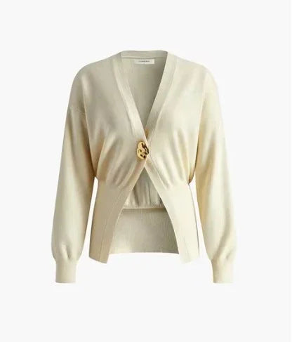 Cream-colored women's cardigan with long sleeves and a single large tortoiseshell button closure