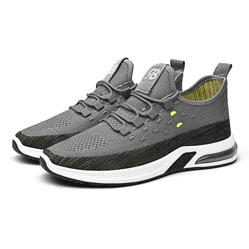 Gray and black breathable knit athletic shoes with white cushioned sole and yellow inner lining