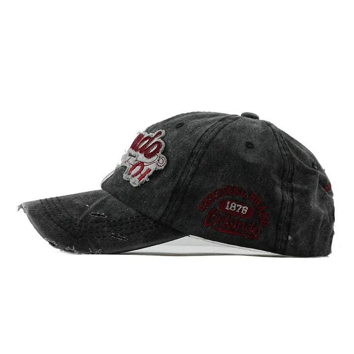 Distressed black baseball cap with red embroidered Orlando 1876 logo and vintage worn look