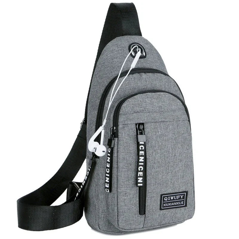 Gray crossbody sling backpack with black strap and white earphones, multiple zippered pockets
