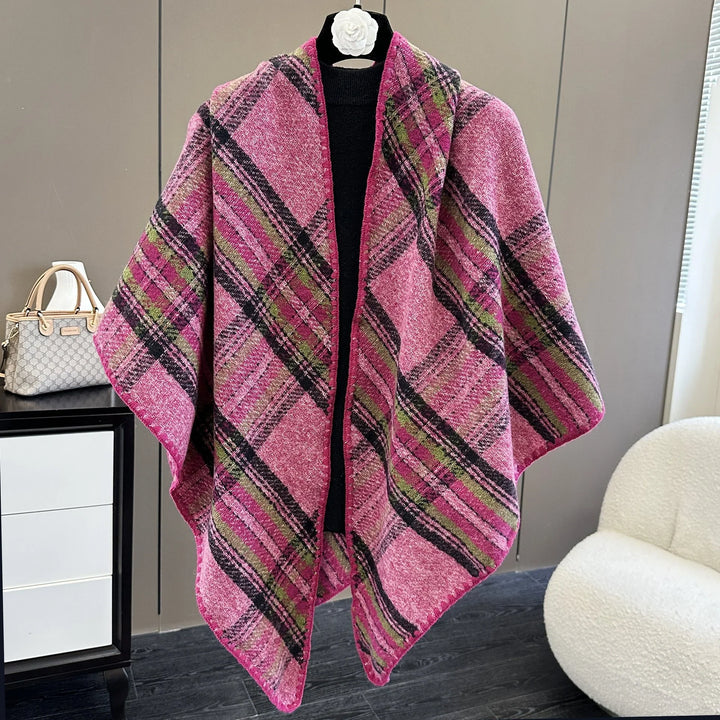 Pink plaid woolen shawl displayed on black mannequin against modern interior with handbag and white chair