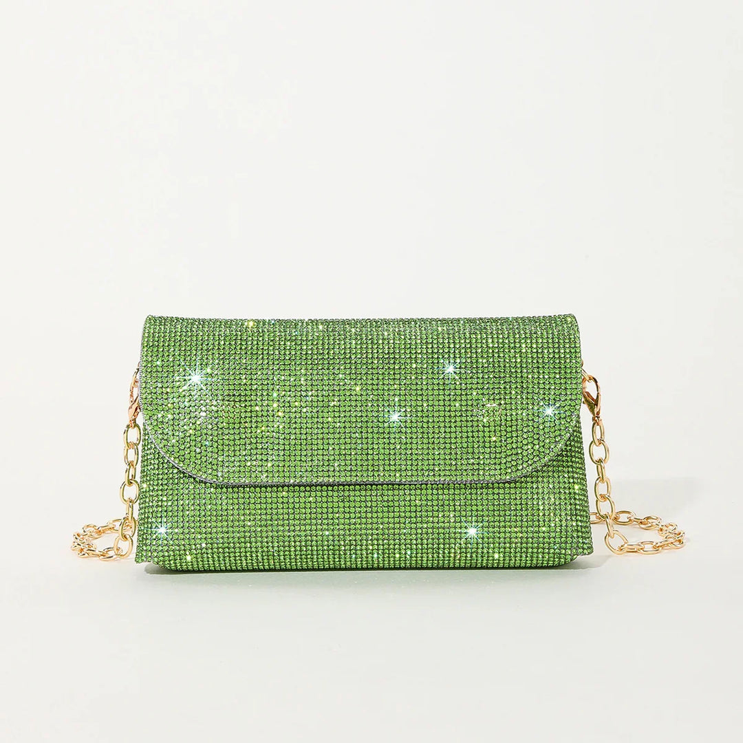 Sparkling green rhinestone clutch bag with gold chain strap on white background