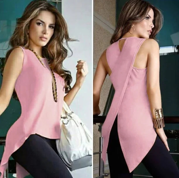 Woman wearing sleeveless pink asymmetrical top paired with black pants, styled with gold accessories