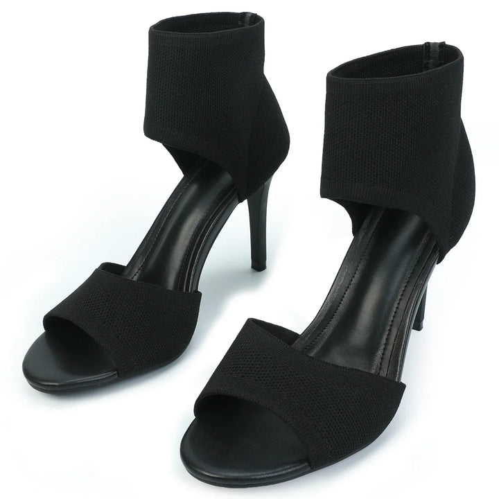 Pair of black open-toe high heel sandals with wide ankle straps and sleek design