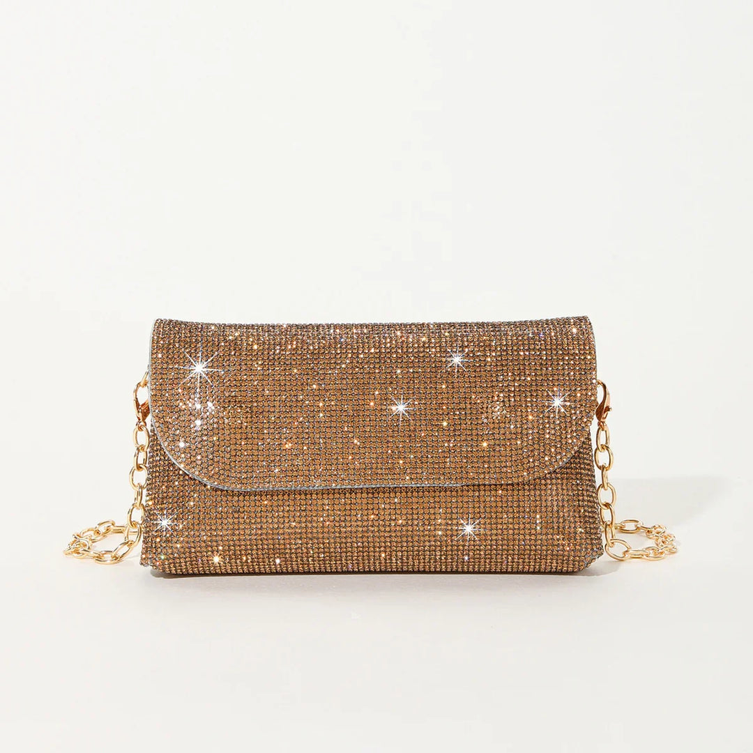 Sparkling gold rhinestone evening clutch bag with gold chain strap on white background
