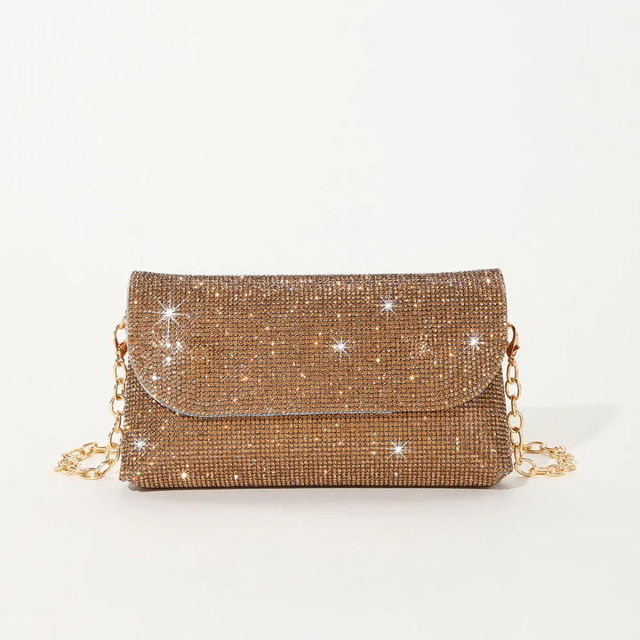 Sparkling gold rhinestone evening clutch bag with gold chain strap on white background