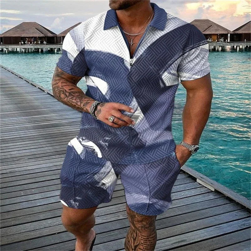 Man wearing blue and white patterned short-sleeve shirt and shorts standing on wooden dock by overwater bungalows