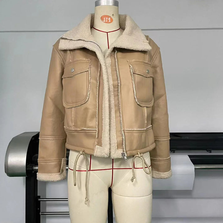 Beige cropped shearling jacket with large front pockets and drawstring on a mannequin