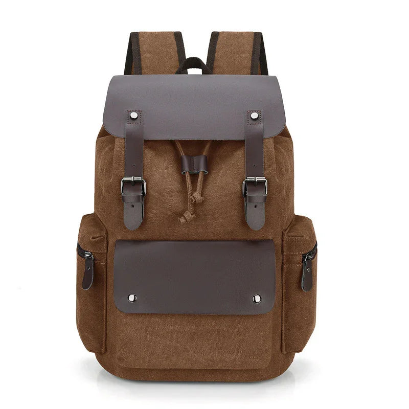 brown canvas backpack with leather straps, front pocket, and side zippered compartments