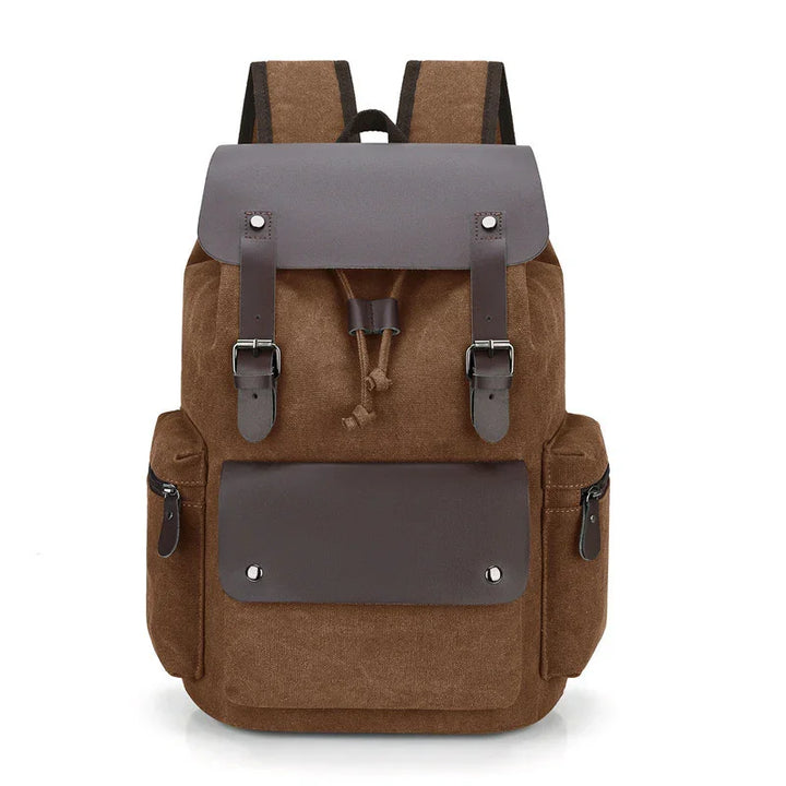 brown canvas backpack with leather straps, front pocket, and side zippered compartments
