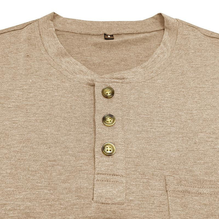 Close-up of beige Henley shirt with three brown buttons and round neckline