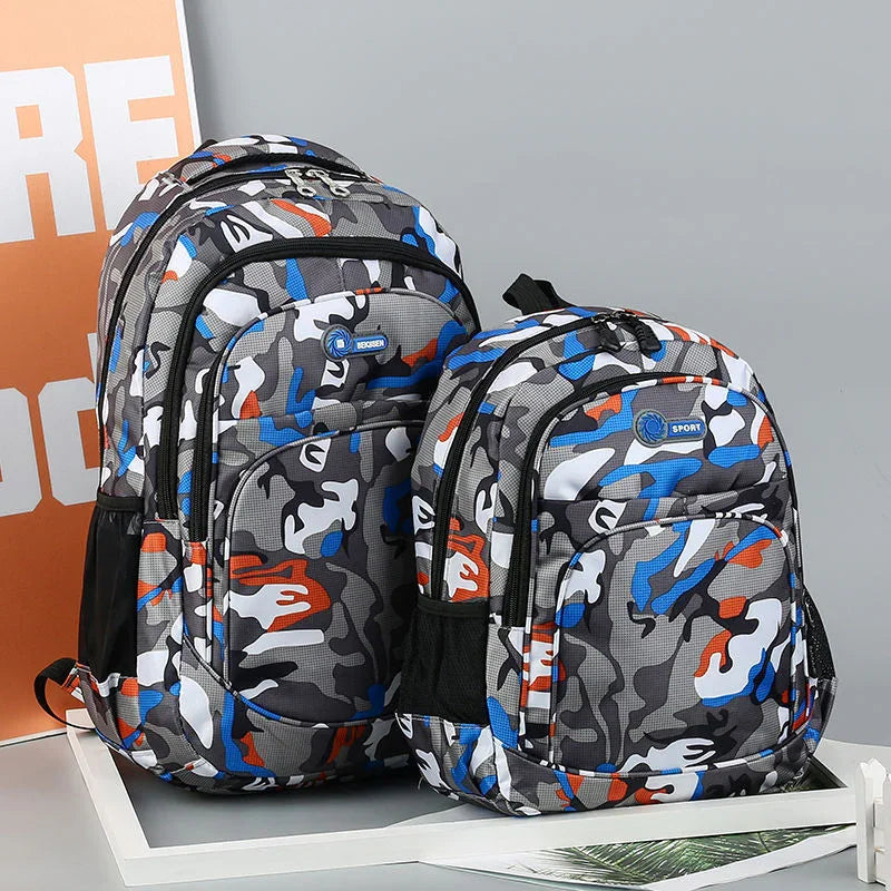 Two camo-patterned backpacks in gray, blue, white, and orange with multiple compartments on a white frame