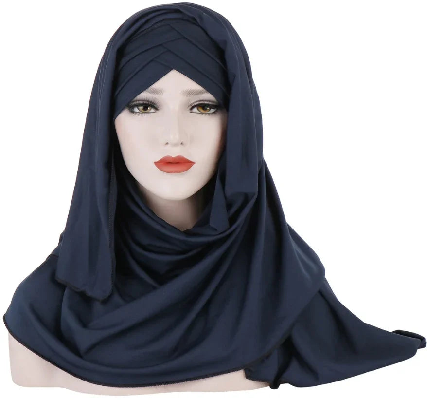 female mannequin wearing a navy blue layered hijab scarf with draped fabric on white background