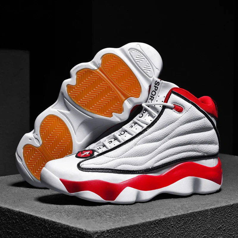 white and red high-top sports sneakers with orange soles displayed on gray platform