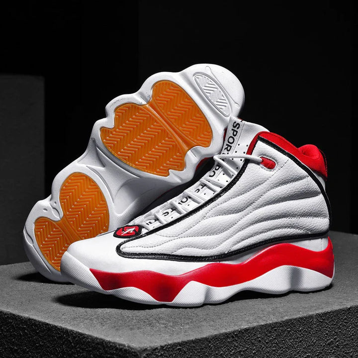 white and red high-top sports sneakers with orange soles displayed on gray platform